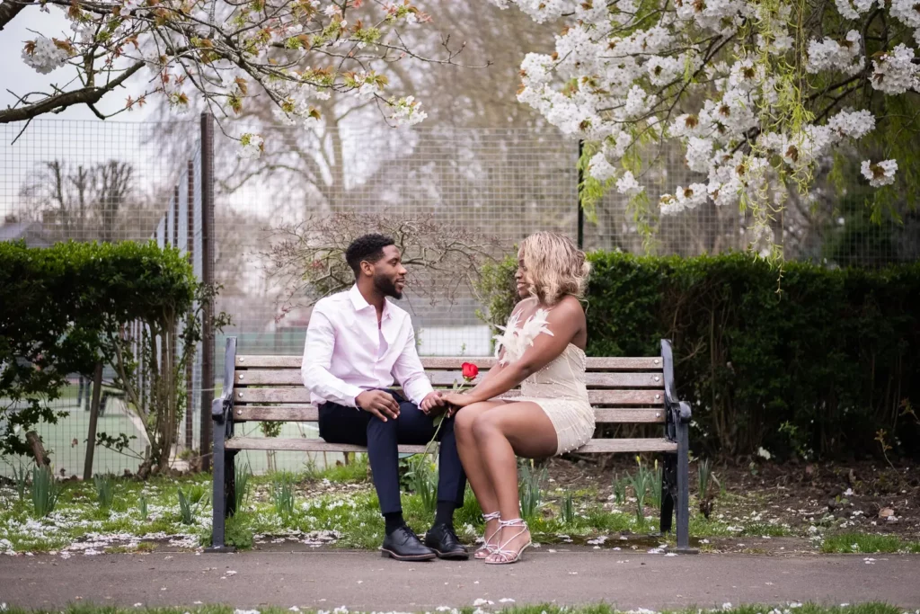 Couples sitting on a bench, spring engagement photoshoot